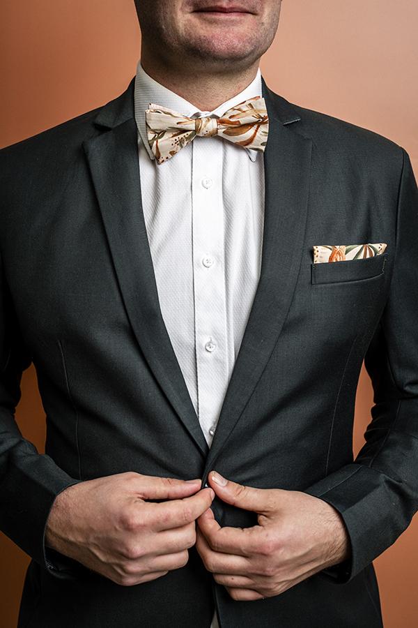 Elegant bow tie with an intricate grass tree design, showcasing a nude background with detailed green and white foliage in a minimalist style, perfect for special occasions