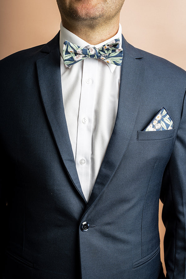 Elegant bow tie with an intricate flowering gum design, showcasing bright pink blossoms and green leaves in a minimalist style, perfect for adding a touch of botanical charm to any outfit