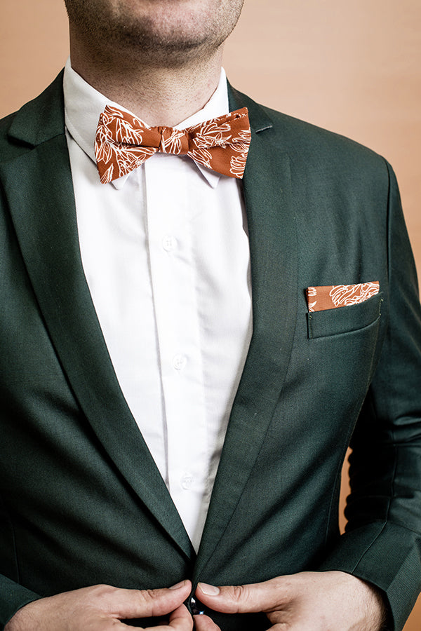 Modern and stylish bow tie featuring a detailed kangaroo paw print in burnt orange, inspired by Australian native flora with intricate yellow and green patterns for a vibrant look
