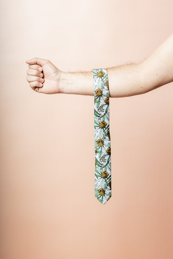 Chic Banksia Grey tie made from 100% cotton, showcasing detailed native Australian flora in soft green and yellow on a grey background