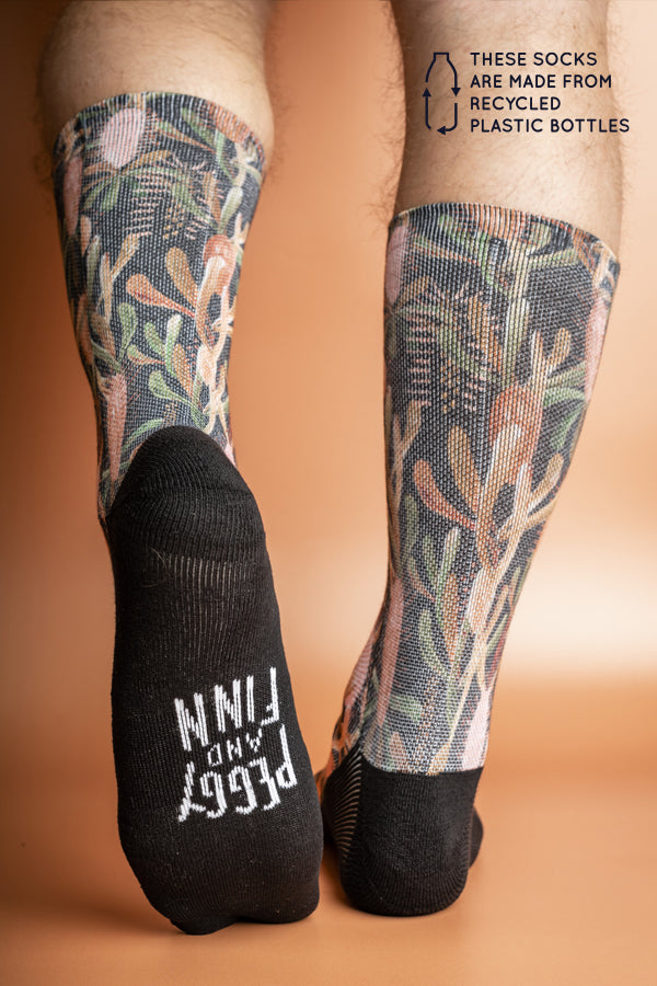 Recycled polyester socks in black, adorned with Australian Grass Tree illustrations, symbolizing growth and survival in harsh conditions