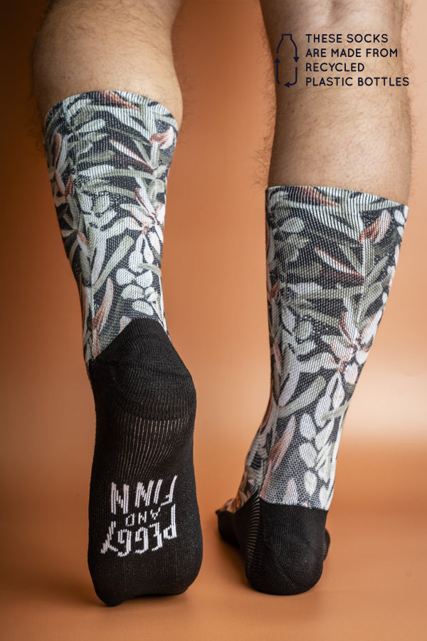 Eco-friendly socks featuring a Protea floral pattern in shades of forest and light green with burnt orange accents, perfect for sustainable style